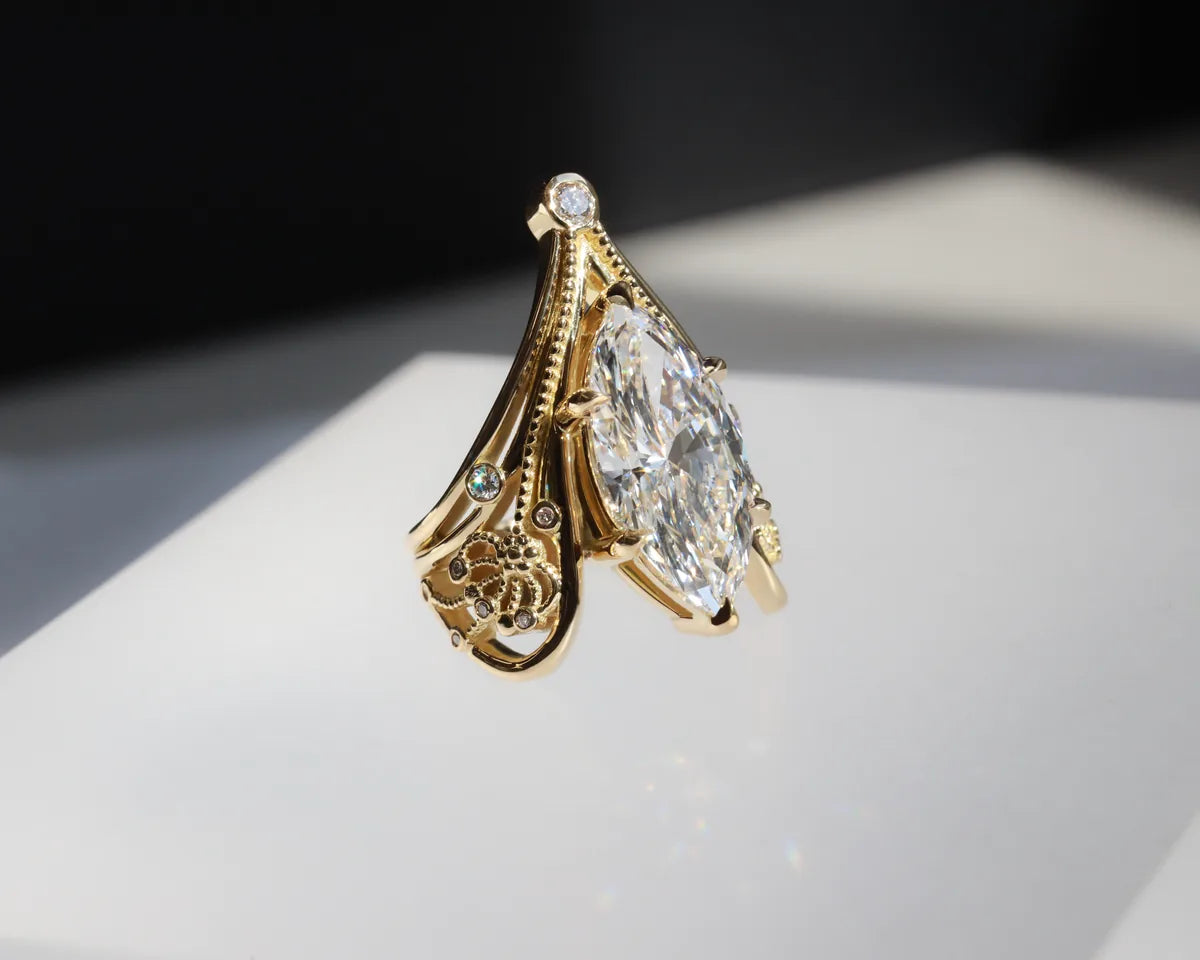 A marquise diamond in a vintage-style yellow gold setting