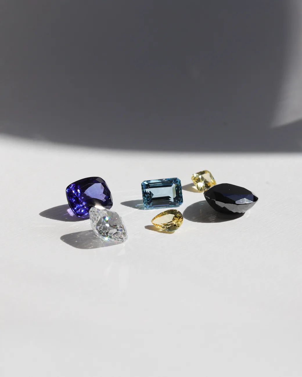 Loose coloured gemstones and a diamond