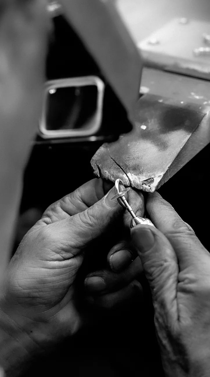 A jeweller working on a ring at the bench